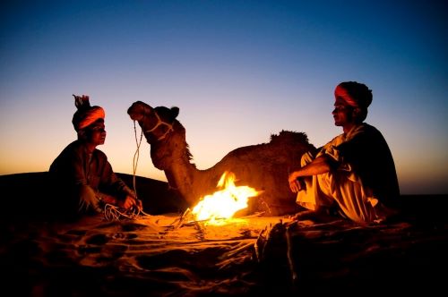 indian-men-resting-by-bonfire-wi